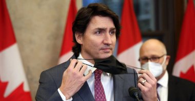 Canada's Prime Minister Justin Trudeau removes his mask during a news conference on Parliament Hill in Ottawa, Canada, Feb. 14, 2022. (AFP Photo)