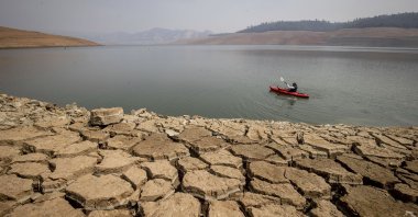 A kayaker paddles in Lake Oroville as water levels remain low due to continuing drought conditions in Oroville, California, U.S., Aug. 22, 2021. (AP Photo)