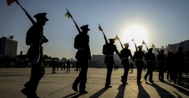 Members of the Ethiopian military parade with national flags attached to their rifles at a rally organized by local authorities to show support for the Ethiopian National Defense Force (ENDF), at Meskel square in downtown Addis Ababa, Ethiopia on Nov. 7, 2021. (AP Photo)