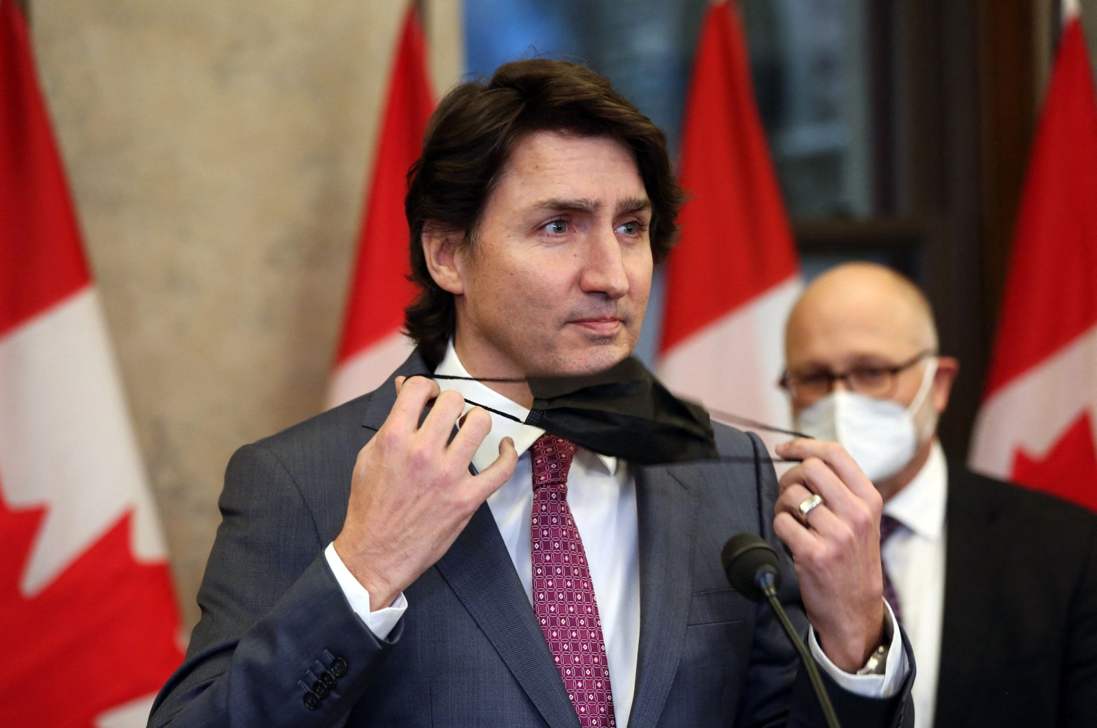 Canada&#039;s Prime Minister Justin Trudeau removes his mask during a news conference on Parliament Hill in Ottawa, Canada, Feb. 14, 2022. (AFP Photo)