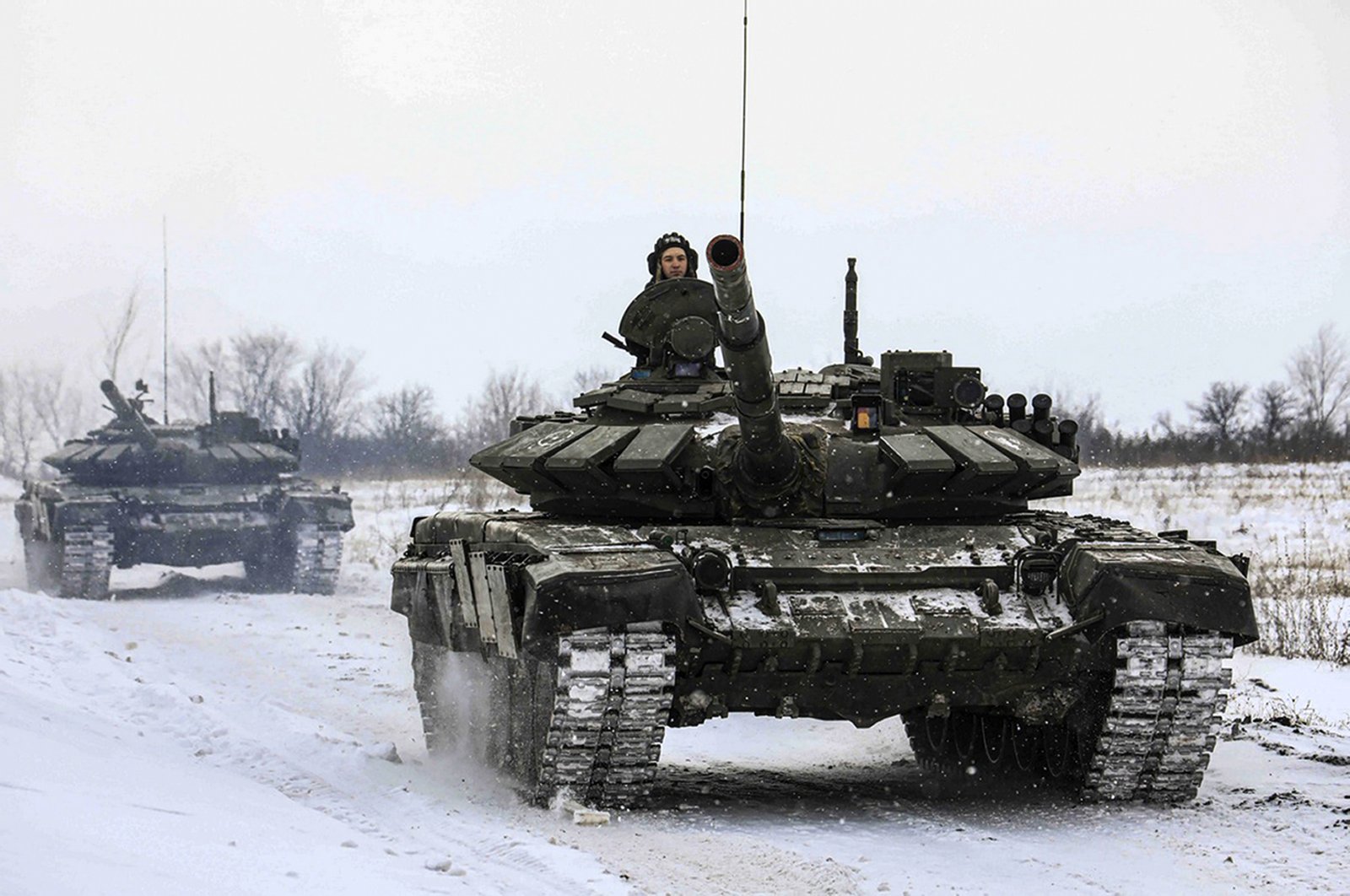 Russian tanks maneuver during a military drill in the Leningrad region, Russia, Feb. 14, 2022. (AP Photo)