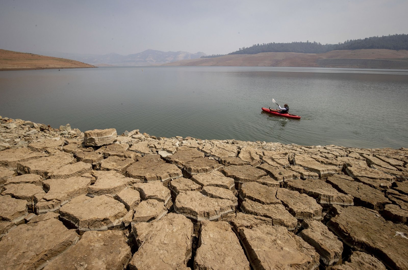 A kayaker paddles in Lake Oroville as water levels remain low due to continuing drought conditions in Oroville, California, U.S., Aug. 22, 2021. (AP Photo)