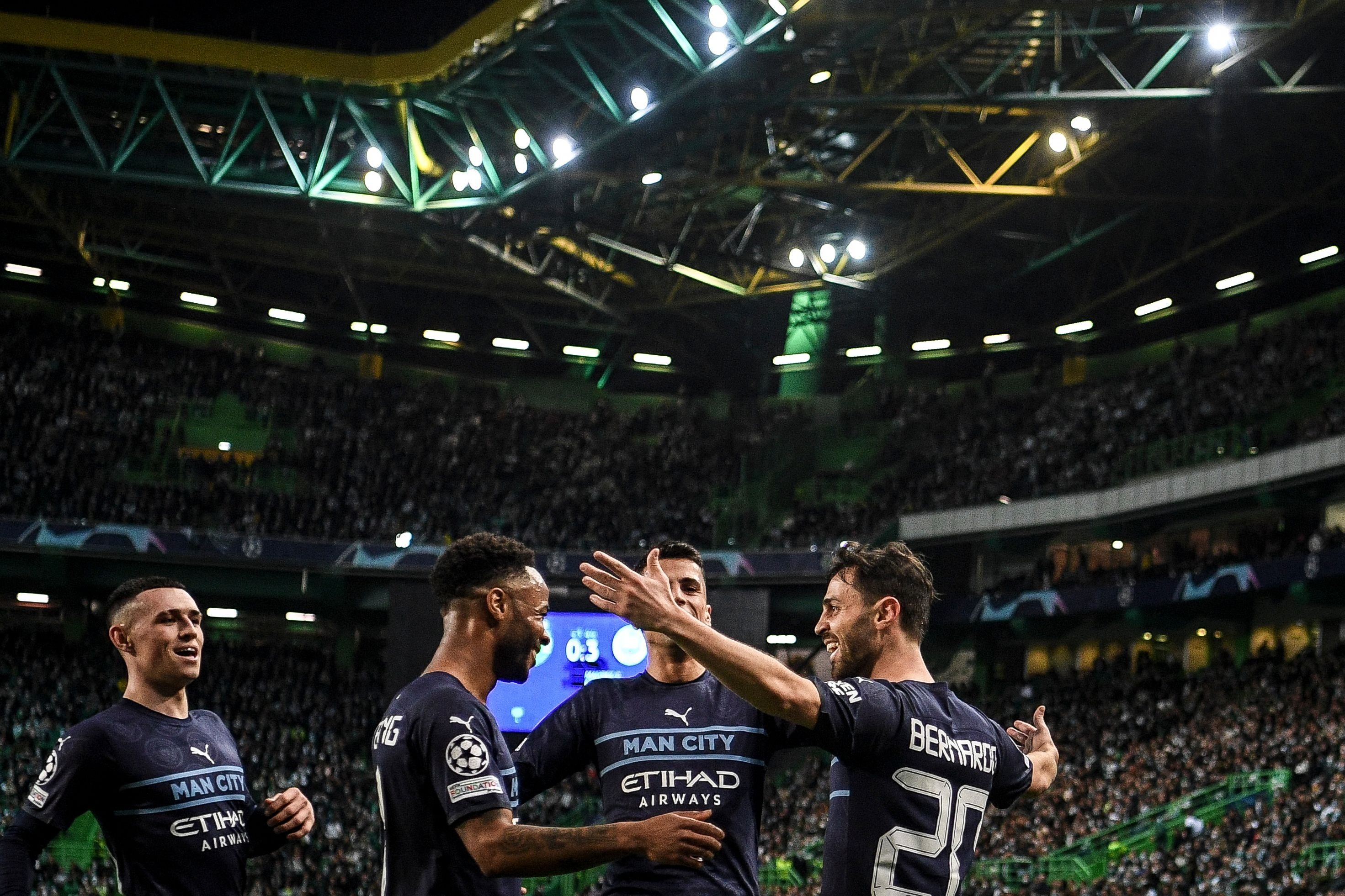 Manchester City's Portuguese midfielder Bernardo Silva (R) celebrates with teammates after scoring his team's fourth goal during the Champions League round of 16 match against Sporting CP, Lisbon, Portugal, Feb. 15, 2022. (AFP Photo)