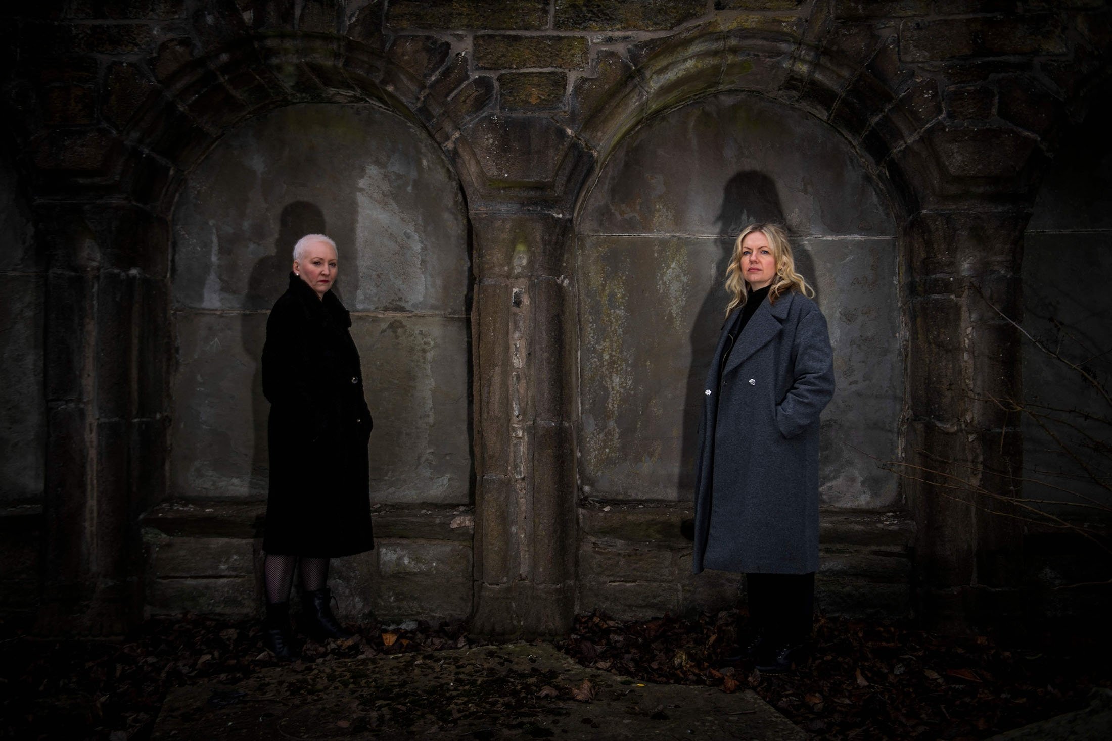 Founder of the association "Witches of Scotland" Claire Mitchell (R) and member Zoe Venditozzi pose for pictures in the Howff Cemetery in Dundee, Scotland, Jan. 30, 2022. (AFP Photo)
