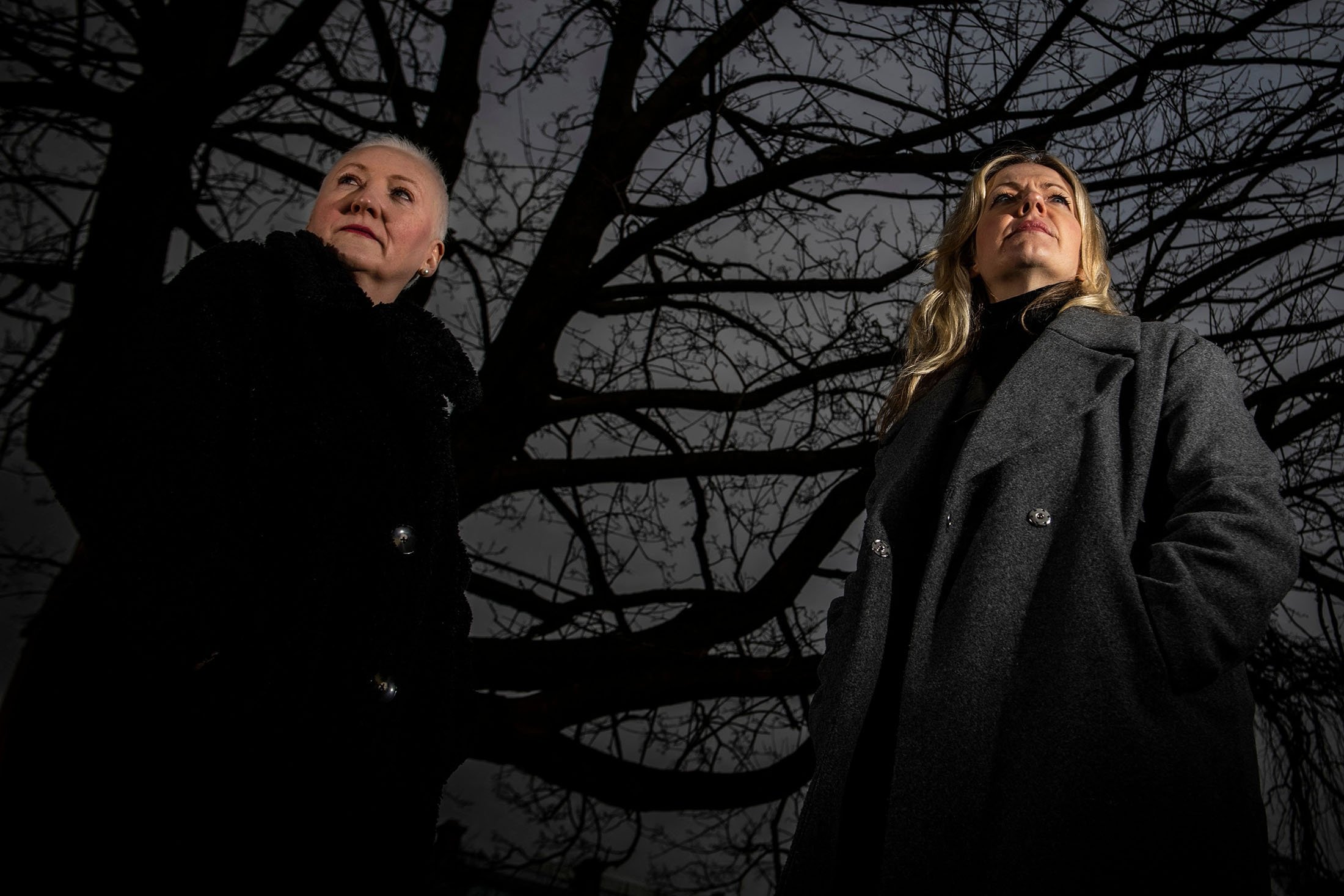 Founder of the association "Witches of Scotland" Claire Mitchell and member Zoe Venditozzi pose for pictures in the Howff Cemetery in Dundee, Scotland, Jan. 30, 2022. (AFP Photo)