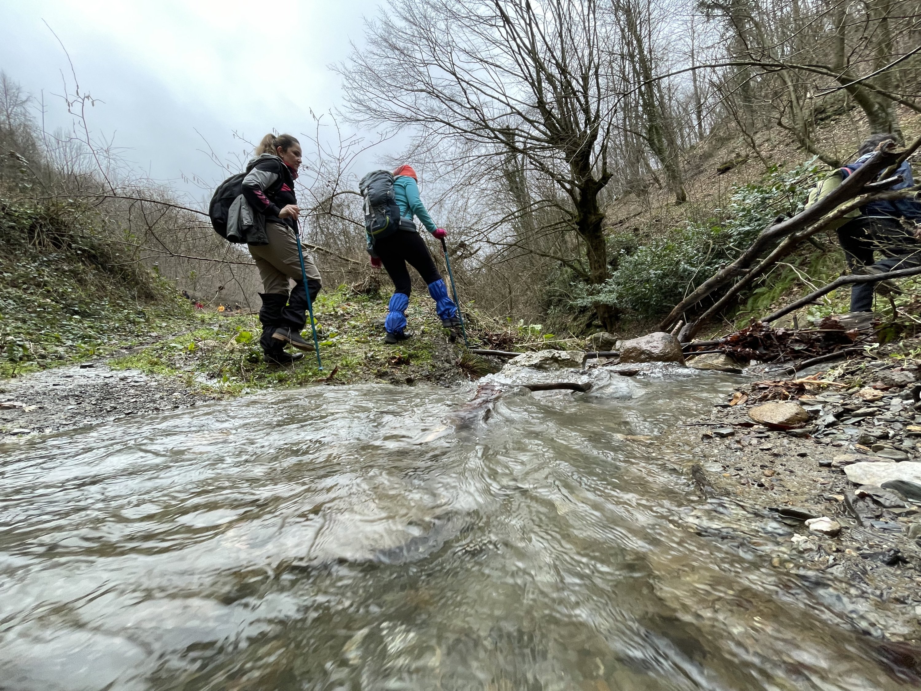 Trekkers crossing a stream along the 16-kilometer Kurtköy-Güneyköy part of the 801-kilometer "Sufi Trail" that stretches from Istanbul to Konya in central Turkey and takes 40 days to complete, Feb. 13, 2022. (AA Photo)