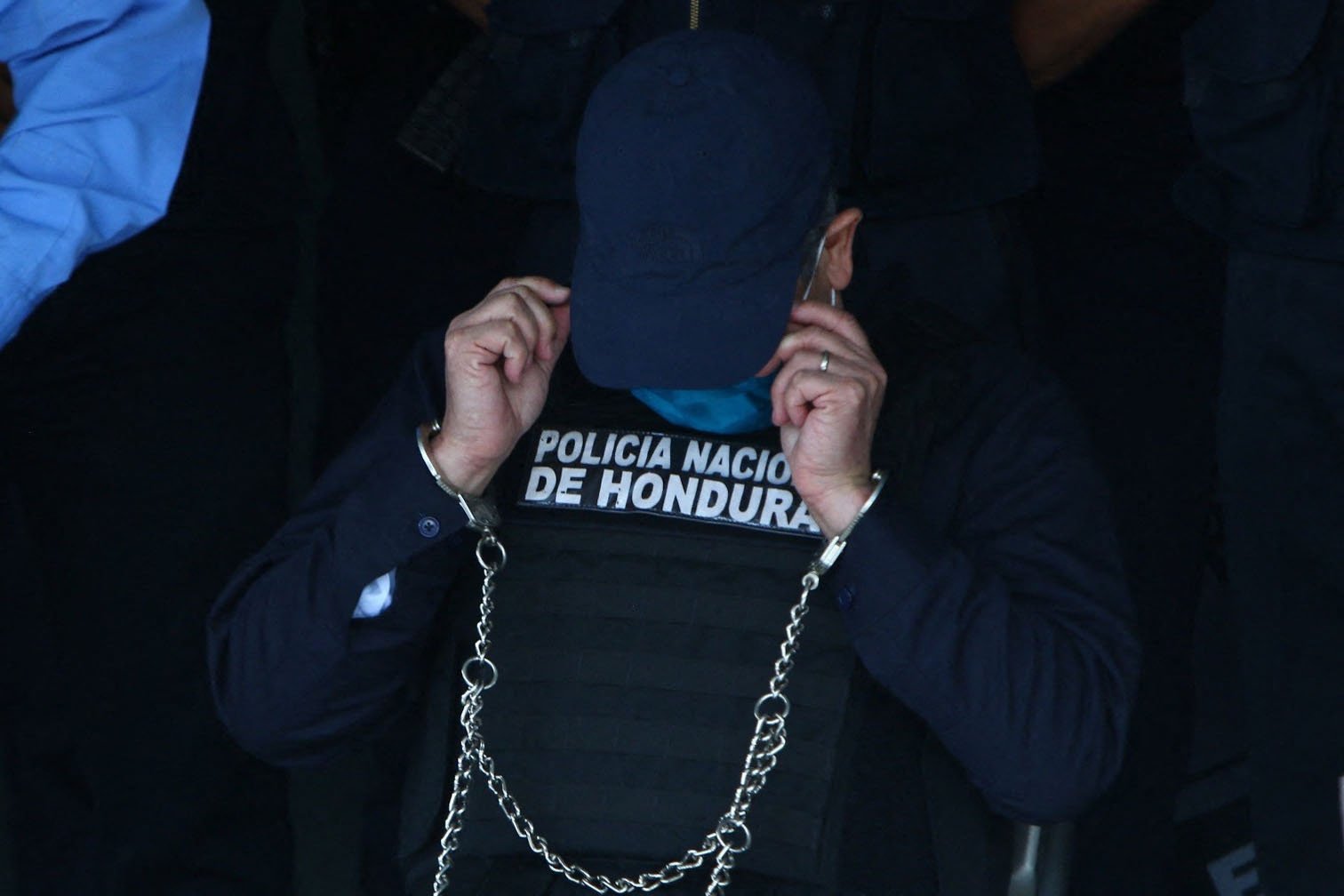Honduran former President Juan Orlando Hernandez is seen handcuffed at police headquarters in Tegucigalpa, Honduras, Feb. 15, 2022. (AFP Photo)