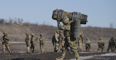 A Ukrainian serviceman carries an NLAW anti-tank weapon during an exercise in the Joint Forces Operation, in the Donetsk region, eastern Ukraine, Feb. 15, 2022. (AP Photo)
