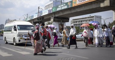 Pedestrians cross a street in downtown Addis Ababa, Ethiopia, Feb. 15, 2022. (AP Photo)