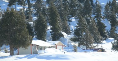 Snow reaches up to 2 meters at Erdemli, which is located 30 kilometers from the seashore, while people spend a summer day at the beach, Erdemli, Mersin, southeastern Turkey, Feb. 11, 2022. (IHA Photo)