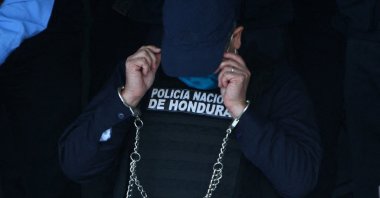 Honduran former President Juan Orlando Hernandez is seen handcuffed at police headquarters in Tegucigalpa, Honduras, Feb. 15, 2022. (AFP Photo)