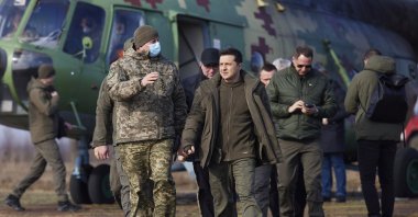 Ukrainian President Volodymyr Zelenskyy, (C), arrives to attend a military drill outside the city of Rivne, northern Ukraine, Wednesday, Feb. 16, 2022. (Ukrainian Presidential Press Office via AP)