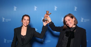 Spanish director and screenwriter Carla Simon (R) and producer Maria Zamora pose during a photo call after being awarded the Golden Bear for Best Film award for the film &quot;Alcarras&quot; after the awards ceremony of the 72nd Berlinale Film Festival in Berlin, Germany, Feb. 16, 2022. (AFP Photo)