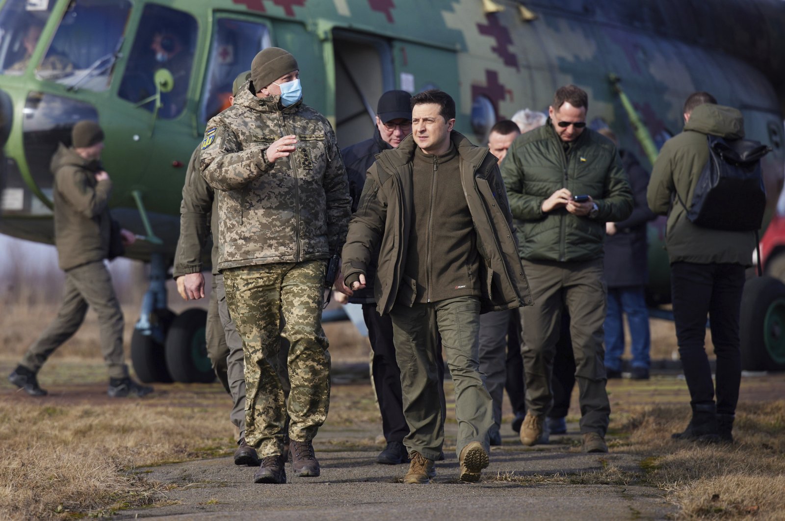 Ukrainian President Volodymyr Zelenskyy, (C), arrives to attend a military drill outside the city of Rivne, northern Ukraine, Wednesday, Feb. 16, 2022. (Ukrainian Presidential Press Office via AP)