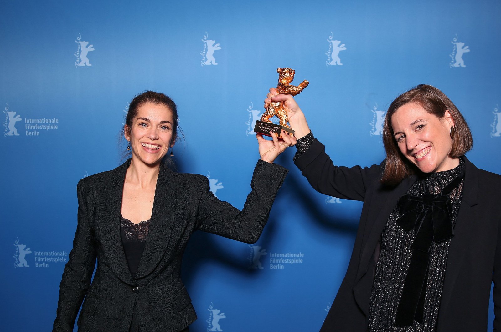 Spanish director and screenwriter Carla Simon (R) and producer Maria Zamora pose during a photo call after being awarded the Golden Bear for Best Film award for the film &quot;Alcarras&quot; after the awards ceremony of the 72nd Berlinale Film Festival in Berlin, Germany, Feb. 16, 2022. (AFP Photo)