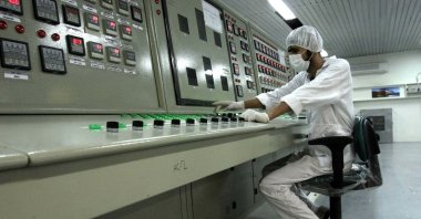 An Iranian technician works at the Uranium Conversion Facility just outside the city of Isfahan, 410 kilometers (255 miles) south of the capital Tehran, Iran, Feb. 3, 2007. (AP Photo)