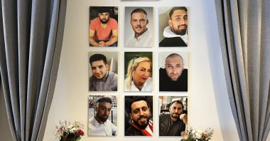 The photos of the victims of the Hanau racist attack hang on the wall in the place where the bloody attack took place, Hanau, Germany, Feb. 16, 2021. (AA Photo)