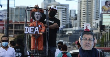 Supporters of the opposition display a mock-up of Honduran President Juan Orlando Hernandez during a protest to demand his resignation over his alleged links to drug trafficking, in Tegucigalpa, Honduras, Feb. 26, 2021. (AFP File Photo)