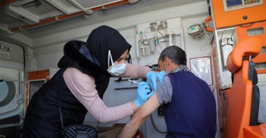 A man gets vaccinated against COVID-19 inside an ambulance, in Şanlıurfa, southeastern Turkey, Feb. 16, 2022. (AA Photo)