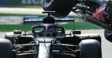 Red Bull driver Max Verstappen's Formula 1 car is airborne over Mercedes driver Lewis Hamilton's car during the Italian F1 GP, Monza, Italy, Sept.12, 2021. (AP Photo)