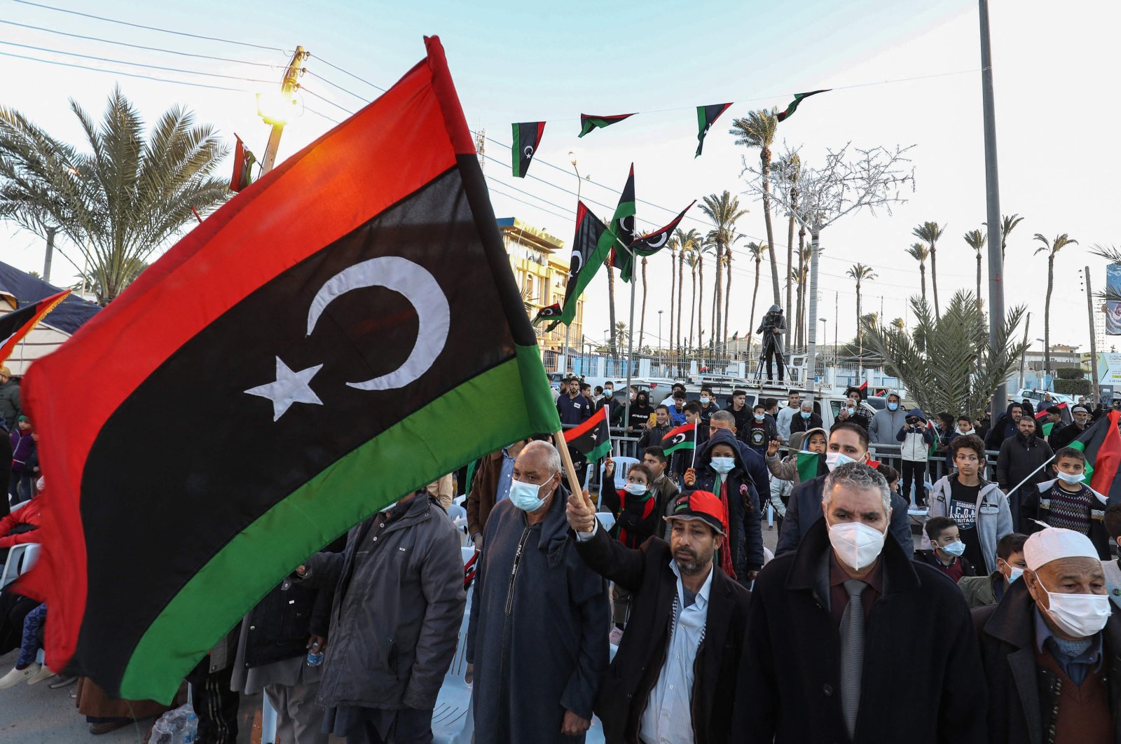 People gather in the coastal Libyan city of Tajura, east of the capital Tripoli on Feb. 16, 2022, as they commemorate the eve of the 11th anniversary of the uprising that toppled longtime strongman Moammar Gadhafi. (AFP Photo)