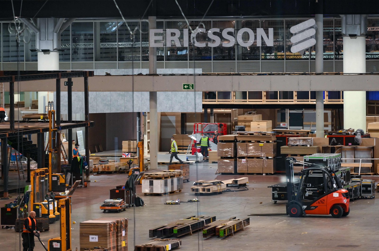 Workers set up the exhibition stand of Ericsson, in preparation of the MWC (Mobile World Congress) in Barcelona, Spain, Feb. 10, 2022. (AFP Photo)