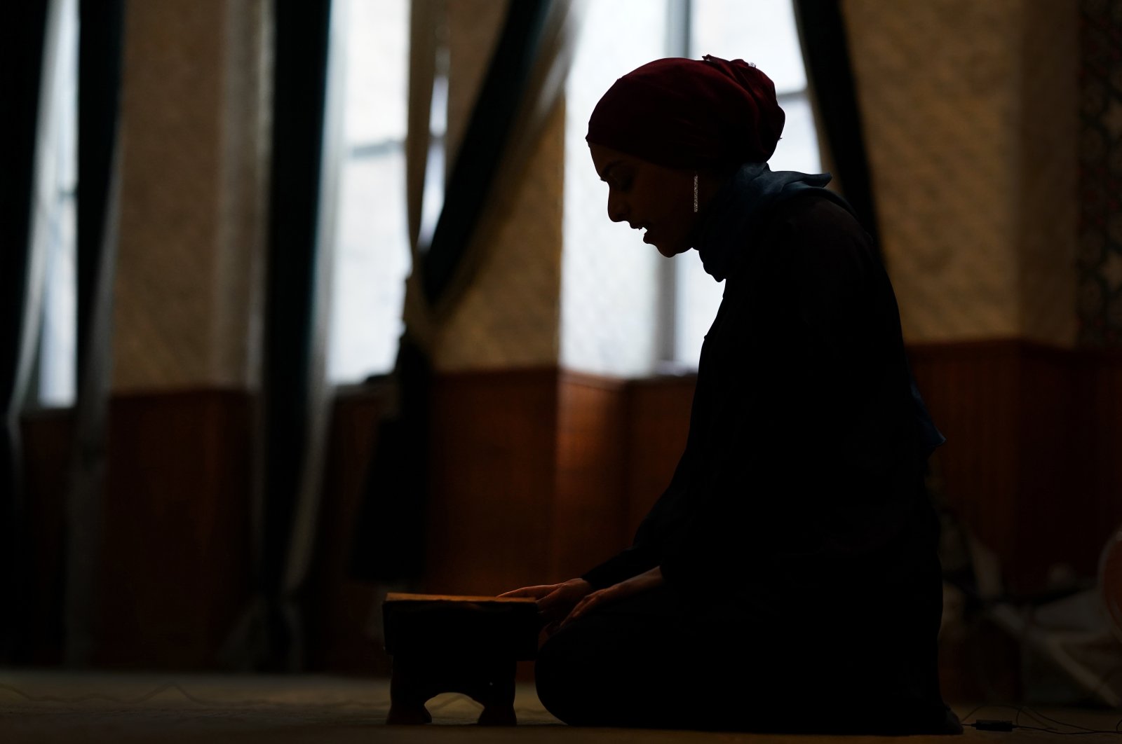 Madinah Javed is silhouetted as she recites the Quran in a prayer room at the American Islamic College, Chicago, U.S., Jan. 27, 2022. (AP Photo)