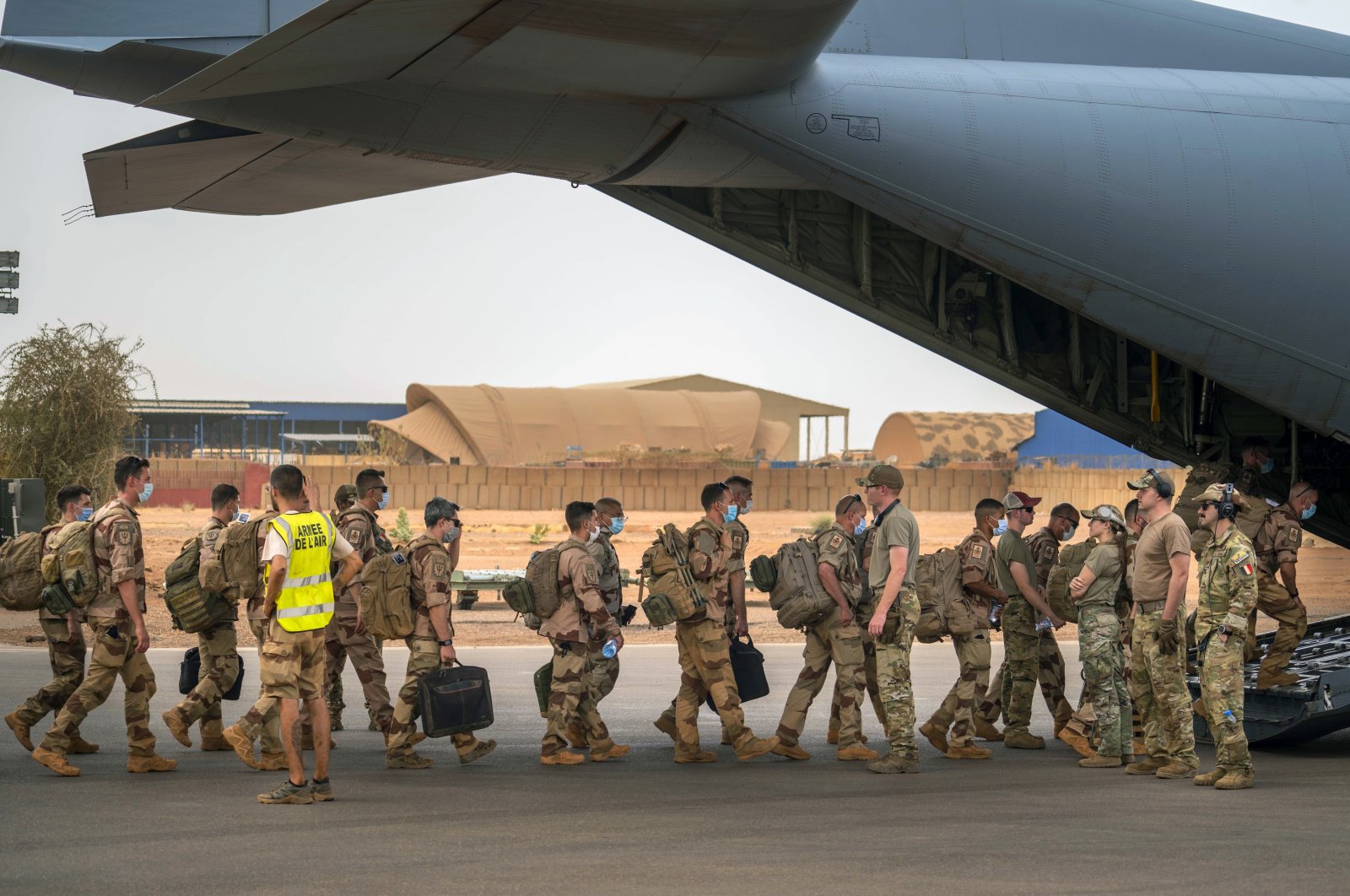 French Barkhane force soldiers who wrapped up a four-month tour of duty in the Sahel board a U.S. Air Force C130 transport plane, leave their base in Gao, Mali, June 9, 2021. (AP Photo)