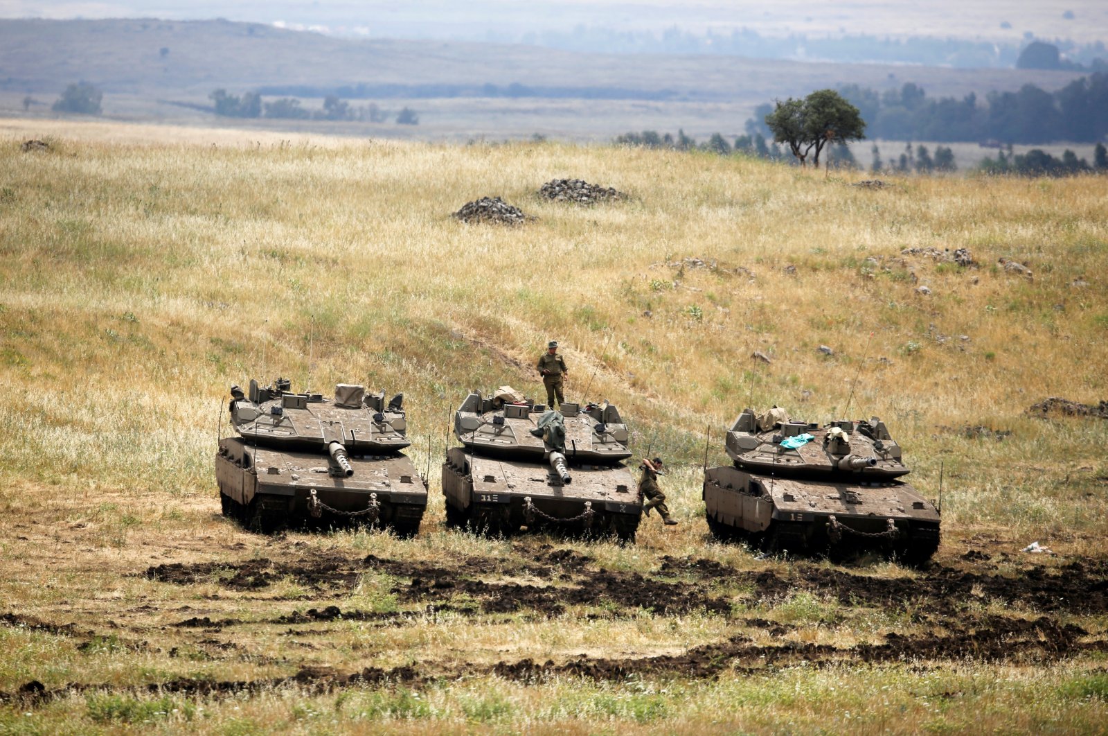 An Israeli soldier stands on a tank as another jumps off it near the Israeli side of the border with Syria in the Israeli-occupied Golan Heights, Israel, May 9, 2018. (Reuters Photo)