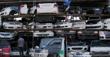 A man stands in front of used car parts of Japanese manufacturer Toyota, at an area selling spare parts for vehicles, in a suburb town of Colombo, Sri Lanka, Feb. 17, 2022. (Reuters Photo)