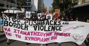 Protesters hold banners and signs, during a protest march against migrant pushbacks and border violence, in central Athens, Greece, 06 February 2022.  EPA/ALEXANDROS VLACHOS