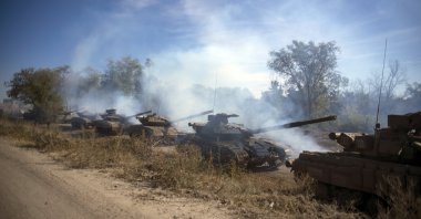 A column of Pro-Russian rebel tanks prepares to move from the line of separation between rebel-held territory and Ukraine-held territory near Oleksandrivka, Luhansk region, eastern Ukraine, Oct. 3, 2015. (AP Photo)