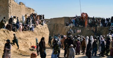 Afghan people gather as rescuers try to rescue a boy trapped for two days down a well in a remote southern village of Shokak, in Zabul province, Afghanistan, Feb. 17, 2022. (AFP Photo)