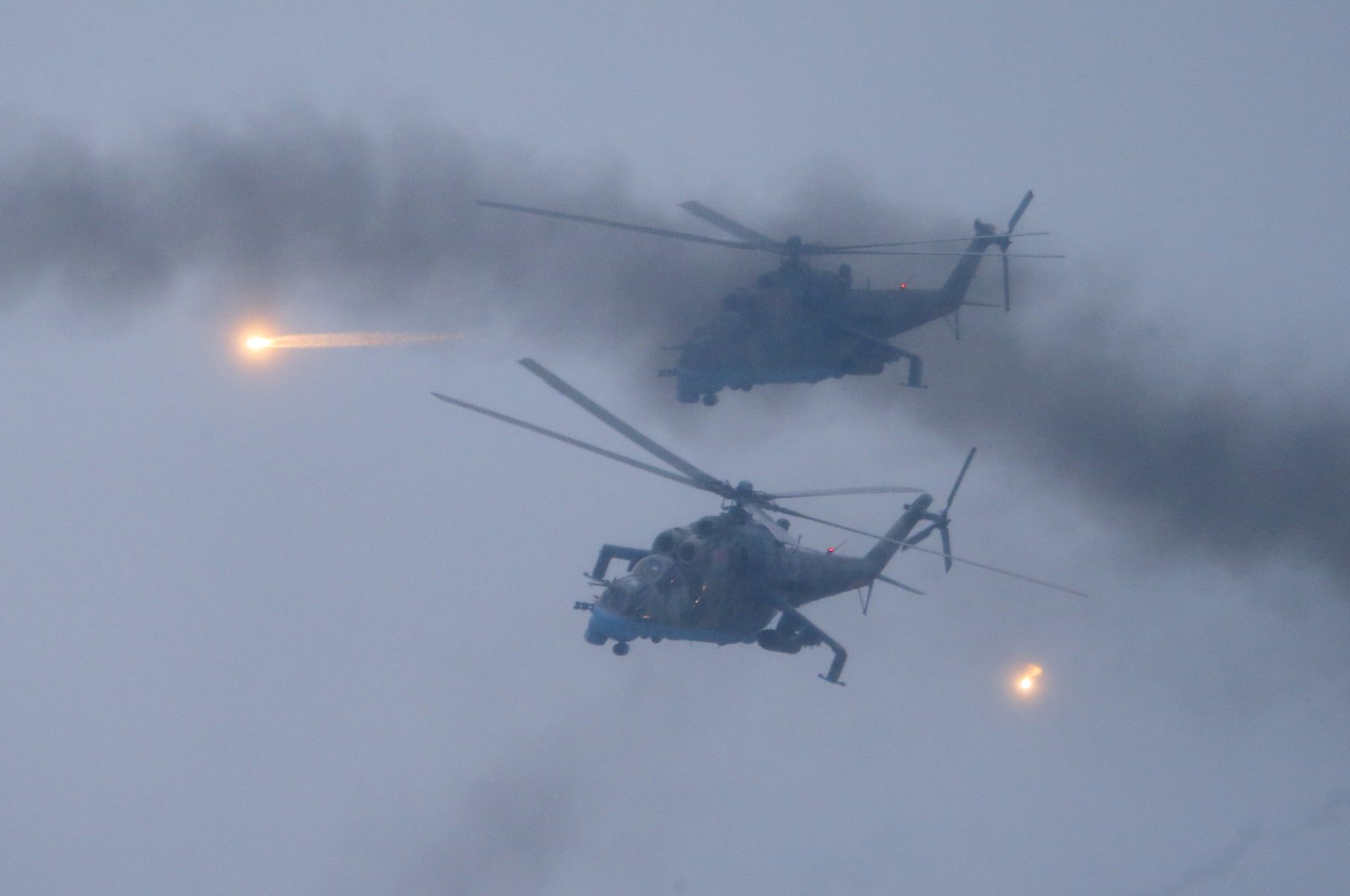 Military helicopters fly over the Osipovichi training ground during the Union Courage-2022 Russia-Belarus military drills near Osipovichi, Belarus, Feb. 17, 2022. (AP Photo)