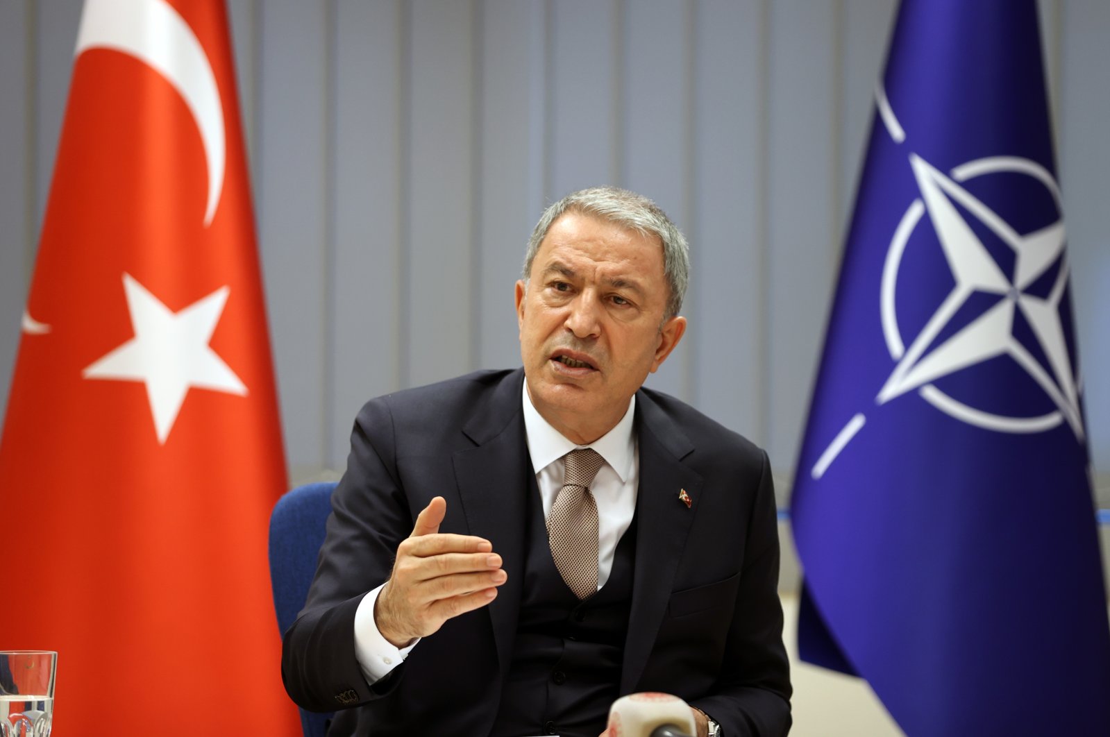 Defense Minister Hulusi Akar is talking to reporters after a NATO meeting in Brussels, Belgium, Feb. 18, 2022. (AA Photo)