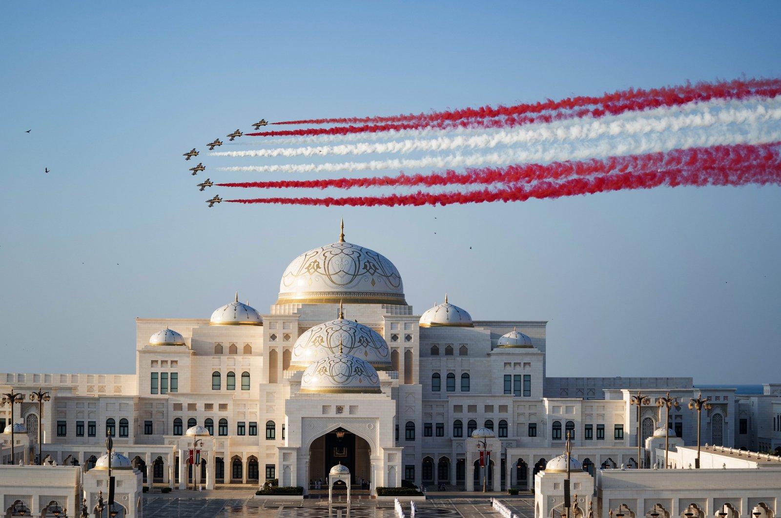 The United Arab Emirates (UAE) Air Force aerobatic display team makes a stunt flying in colors of the Turkish flag, red and white, for President Recep Tayyip Erdoğan&#039;s visit to the country, in the capital Abu Dhabi, UAE, Feb. 14, 2022. (AA Photo)
