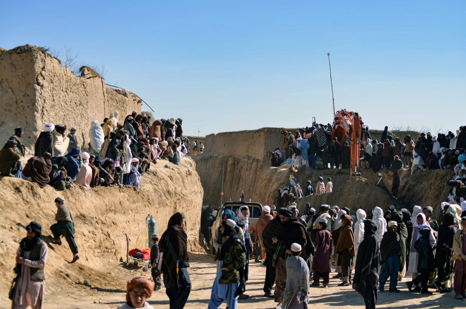 Afghan people gather as rescuers try to rescue a boy trapped for two days down a well in a remote southern village of Shokak, in Zabul province, Afghanistan, Feb. 17, 2022. (AFP Photo)