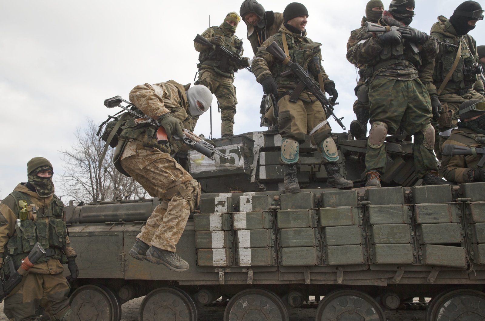 A Russia-backed rebel jumps off a tank in Debaltseve, Ukraine, Friday, Feb. 20, 2015. (AP Photo)