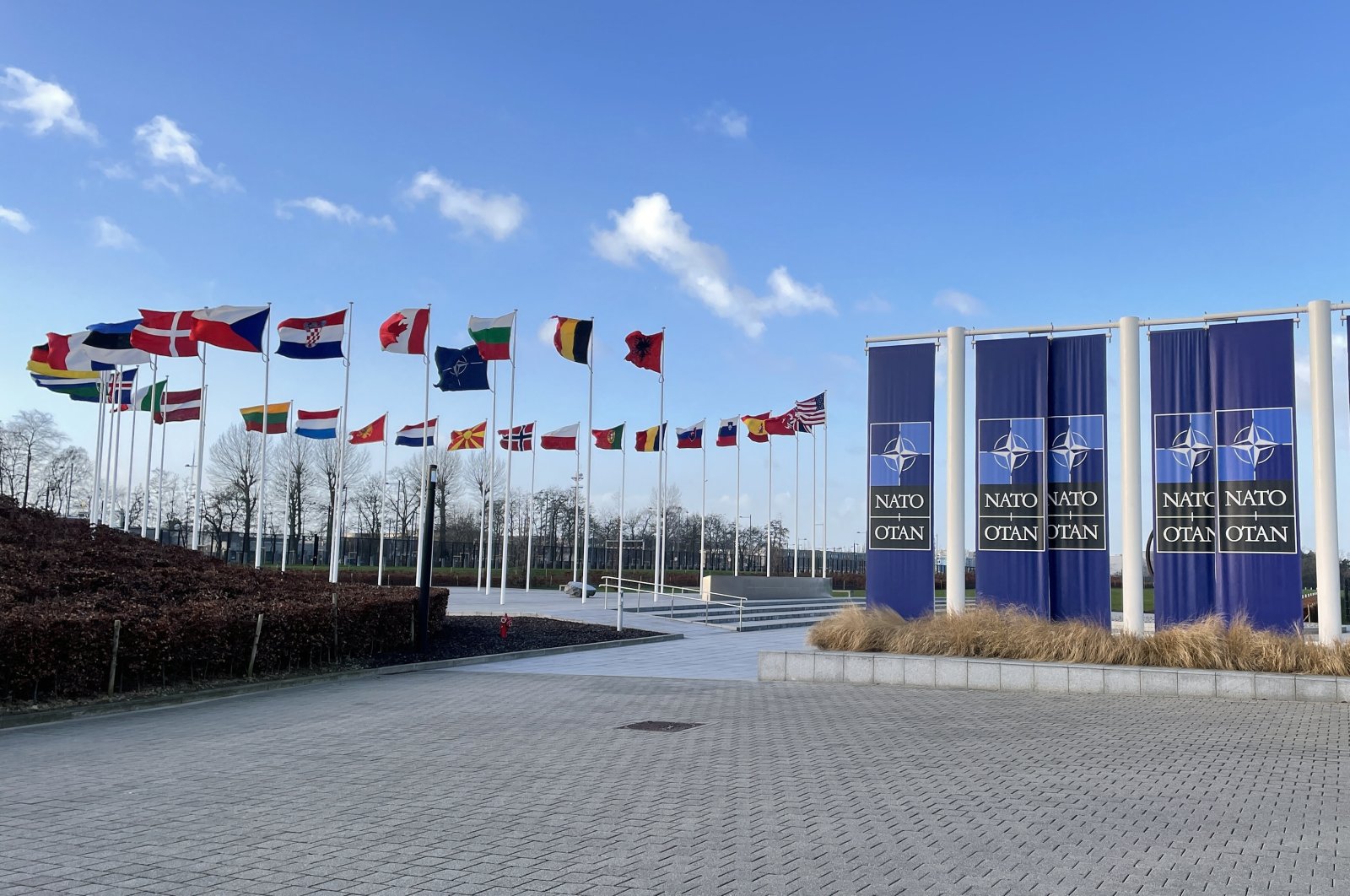 Flags are seen in front of the NATO headquarters in Brussels, Belgium, Feb.17, 2022. (AA Photo)