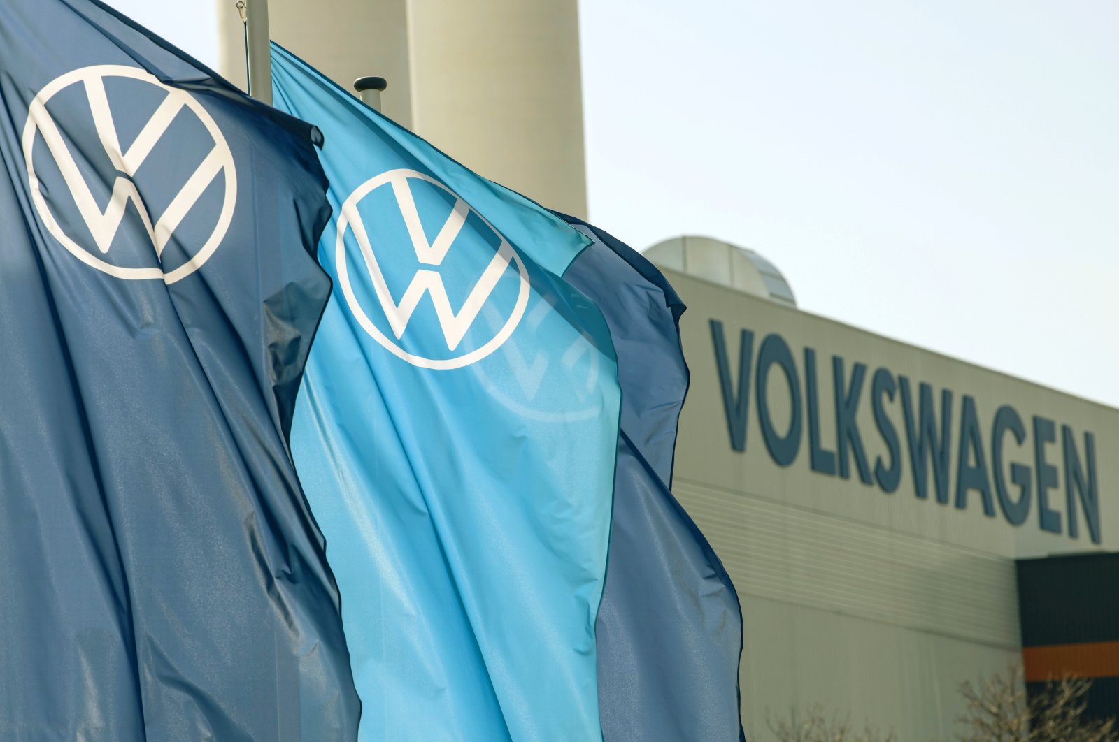 Company logo flags wave in front of a Volkswagen factory building in Zwickau, Germany, April 23, 2020. (AP Photo)