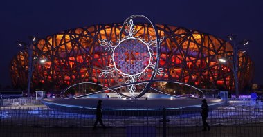 The Olympic flame burning in the center of the snowflake-shaped cauldron is on display near the National Stadium at the 2022 Winter Olympics, Beijing, China, Feb. 17, 2022. (AP Photo)