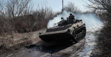 Ukrainian service members ride at a infantry fighting vehicle on the front line near the village of Zaitseve in the Donetsk region, Ukraine, Feb. 19, 2022. (Reuters Photo)
