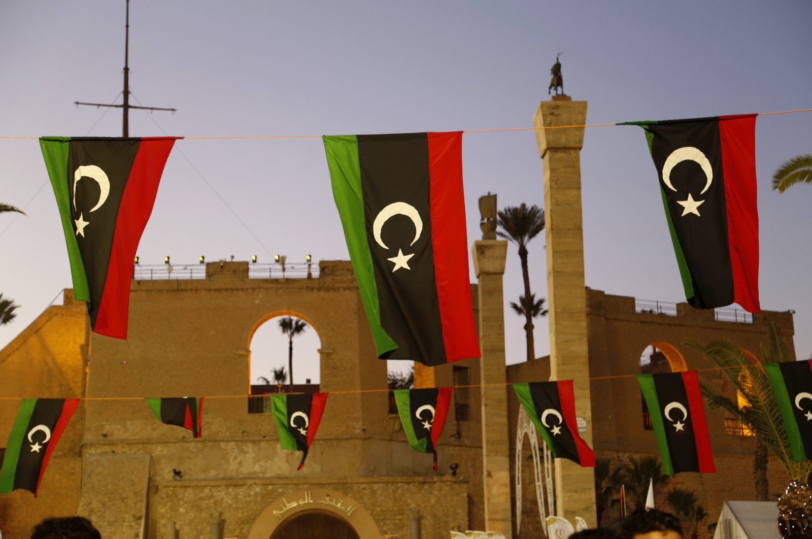 Libyan flags are displayed as people celebrate the February Revolution Day in Martyrs' Square in Tripoli, Libya, Friday, Feb. 18, 2022.  (AP Photo/Yousef Murad)