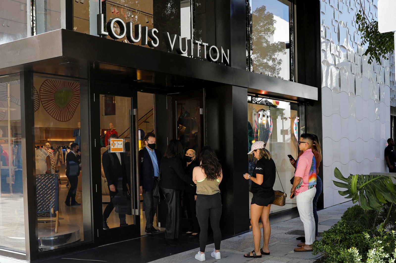 People wait to enter the Louis Vuitton store in Miami Design District, Miami, Florida, U.S., Nov. 30, 2021. (Reuters Photo)
