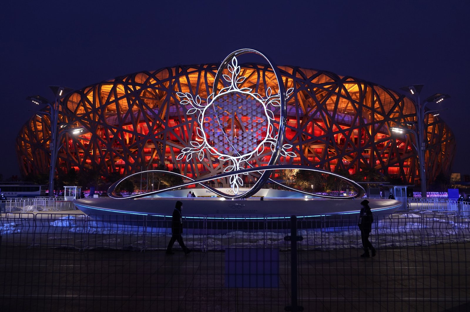 The Olympic flame burning in the center of the snowflake-shaped cauldron is on display near the National Stadium at the 2022 Winter Olympics, Beijing, China, Feb. 17, 2022. (AP Photo)