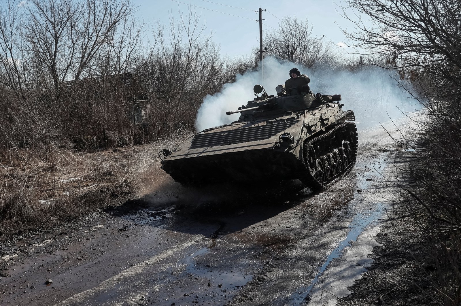 Ukrainian service members ride at a infantry fighting vehicle on the front line near the village of Zaitseve in the Donetsk region, Ukraine, Feb. 19, 2022. (Reuters Photo)