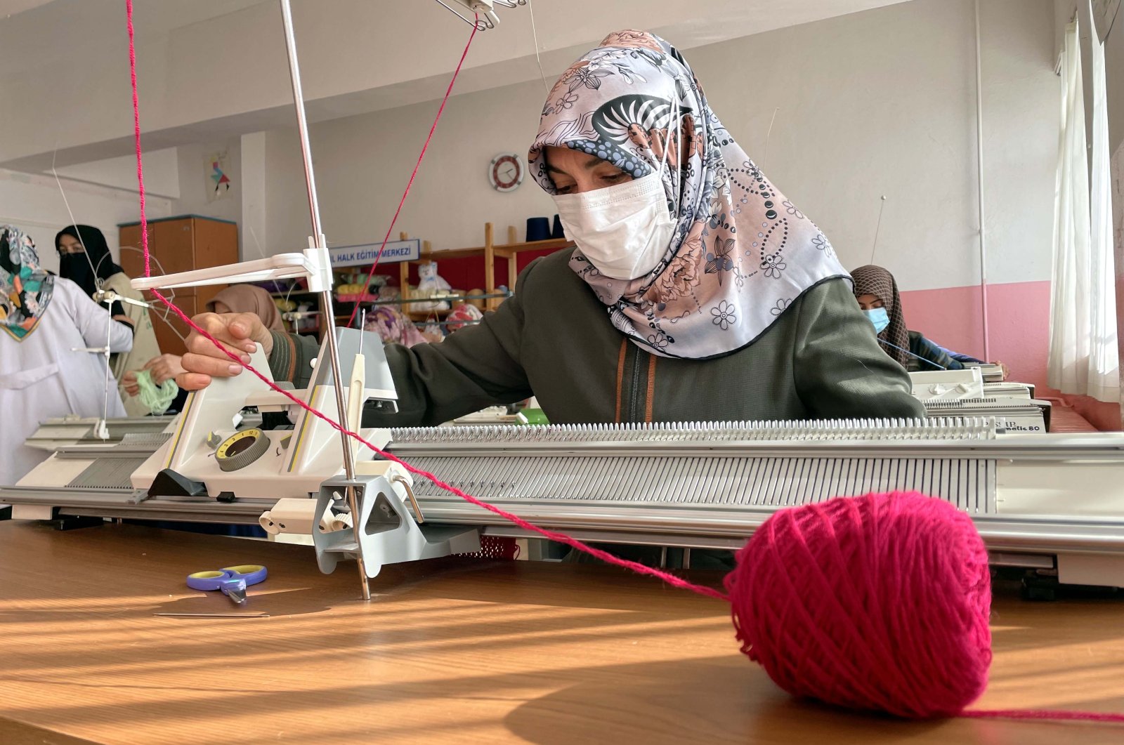 Women knit clothes for children Afghanistan and Syria at the Public Education Center in eastern Elazığ province&#039;s Baskil district, Turkey, Feb. 20, 2022. (AA Photo)