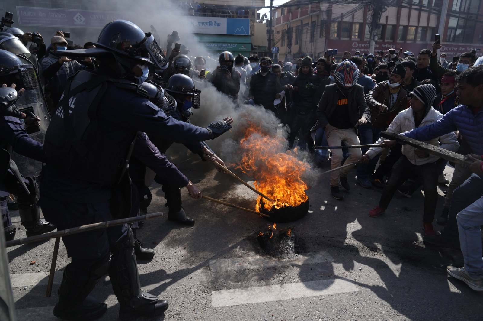 Nepalese protesters opposing a proposed U.S. half billion dollars grant for Nepal clash with police outside as the parliament debates the contentious aid in Kathmandu, Nepal, Feb. 20, 2022. (AP Photo)