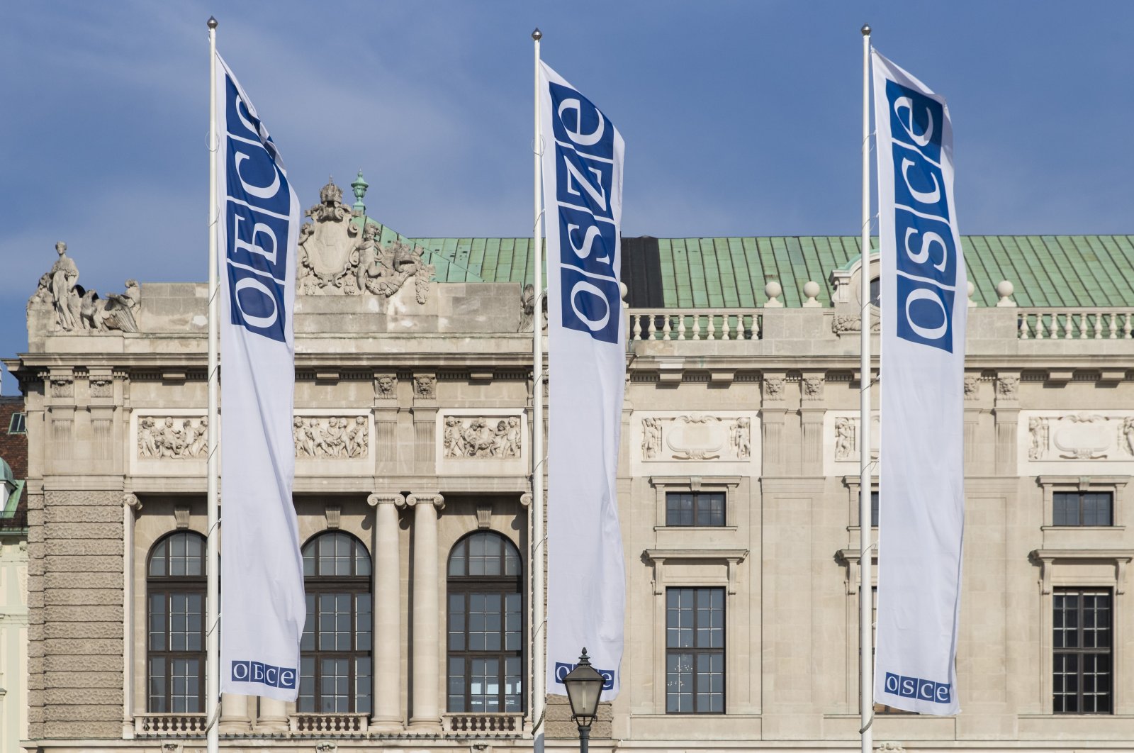 Flags wave in the wind in front of the entrance of the Permanent Council of the Organization for Security and Cooperation in Europe (OSCE) in Vienna, Austria, Feb. 15, 2022. (AP File Photo)