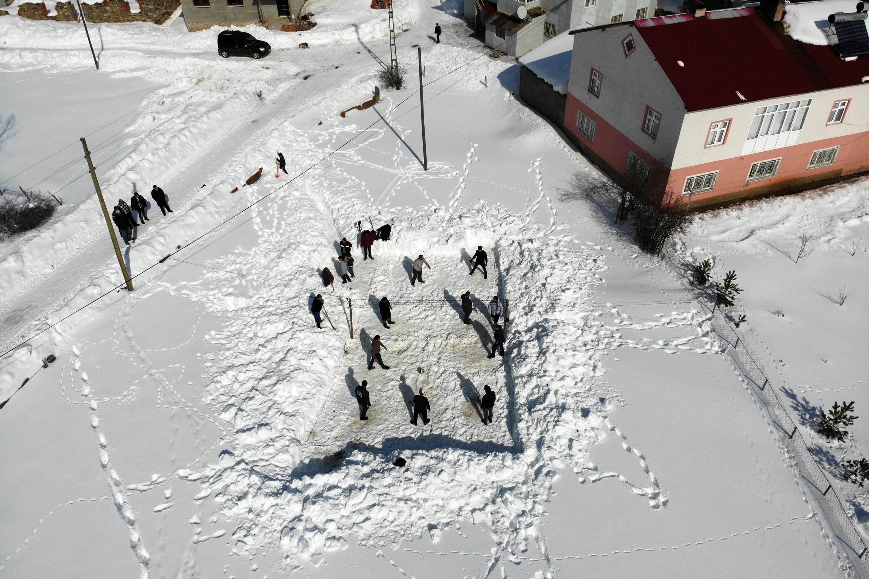 A general view of the locals of Yenice village playing snow volleyball, Gümüşhane, northeastern Turkey, Feb. 21, 2022. (IHA Photo)
